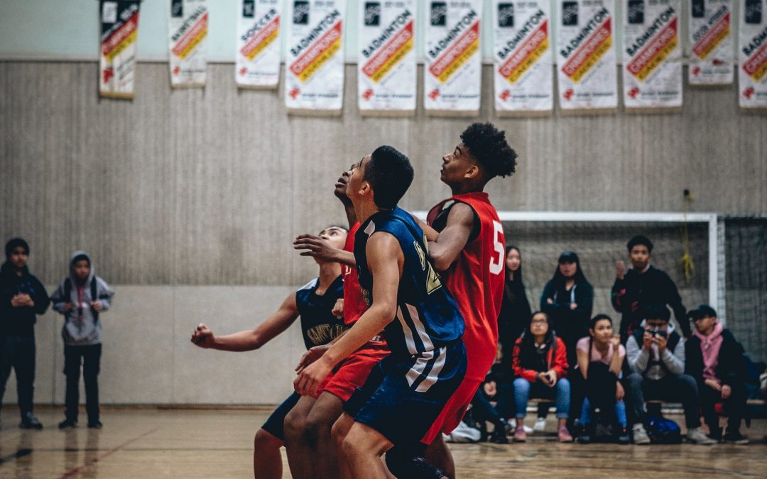 Young basketball players playing on court